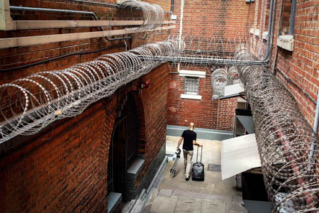 The corridors of the prison are narrow and surrounded by wire fences