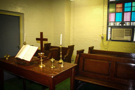 The prayer room is furnished with a simple altar and benches