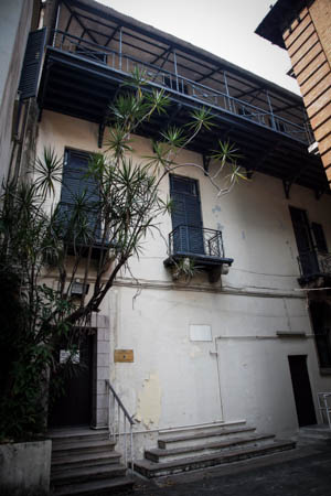 The central entrance of the Superintendent’s House has been boarded up; only the stone staircase remains. 