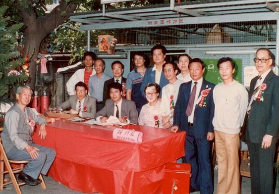 Ng Shui Chuen poses for a photograph with his fellow villagers