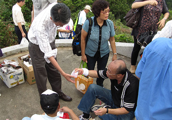 Distributing grave sweeping money at the hill