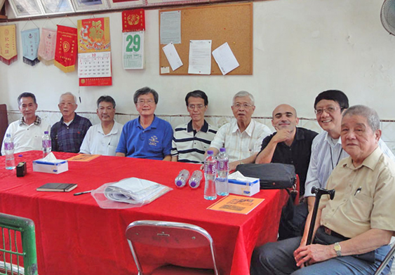 Ng Chiu Pang in a Village Office meeting